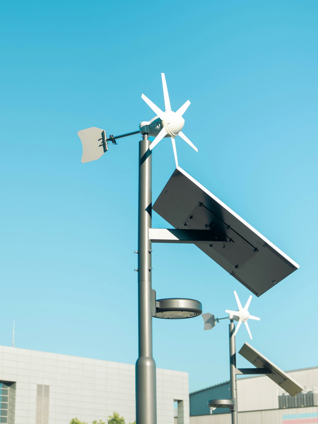 Clean shot of solar panels and tiny wind turbines on poles against a bright blue Tokyo sky. Feels modern and minimal, like the street got an eco upgrade.